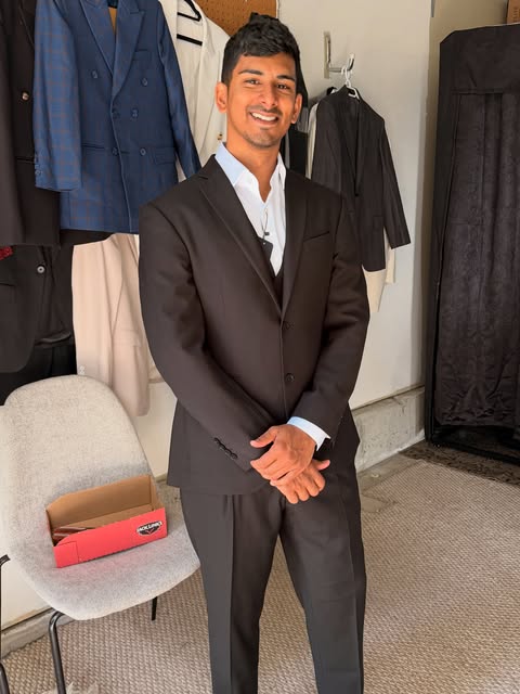 Smiling client in a black custom suit with white shirt